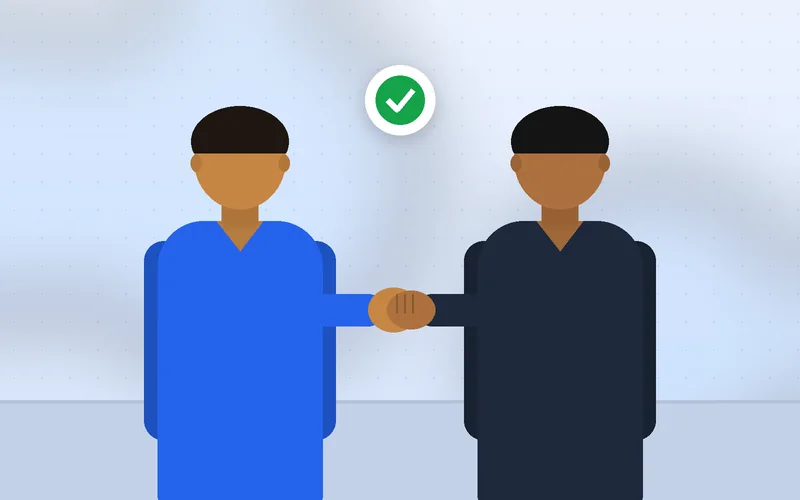 A service professional shakes hands warmly with a client after a consultation
